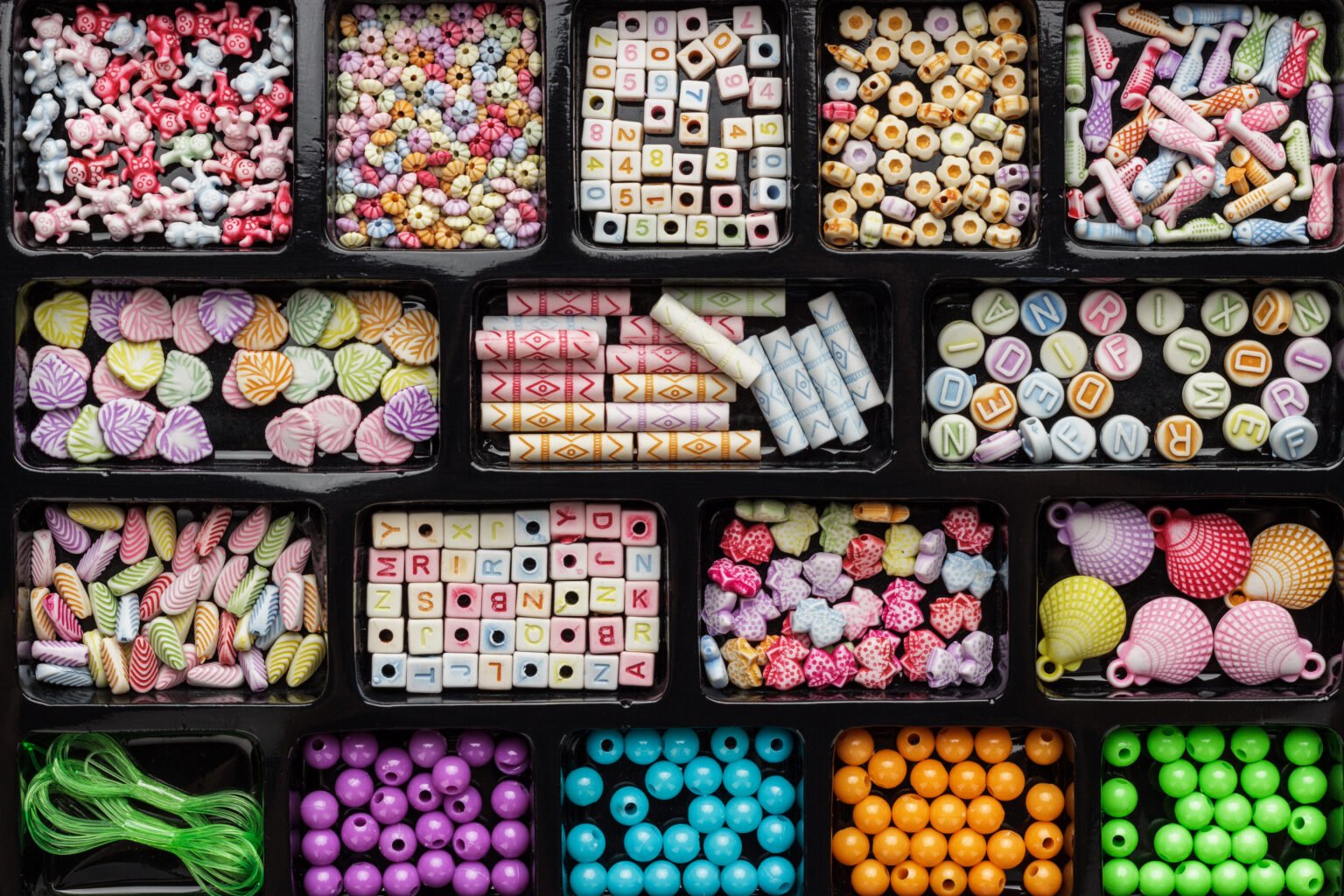 different colorful beads on the brown wooden table
